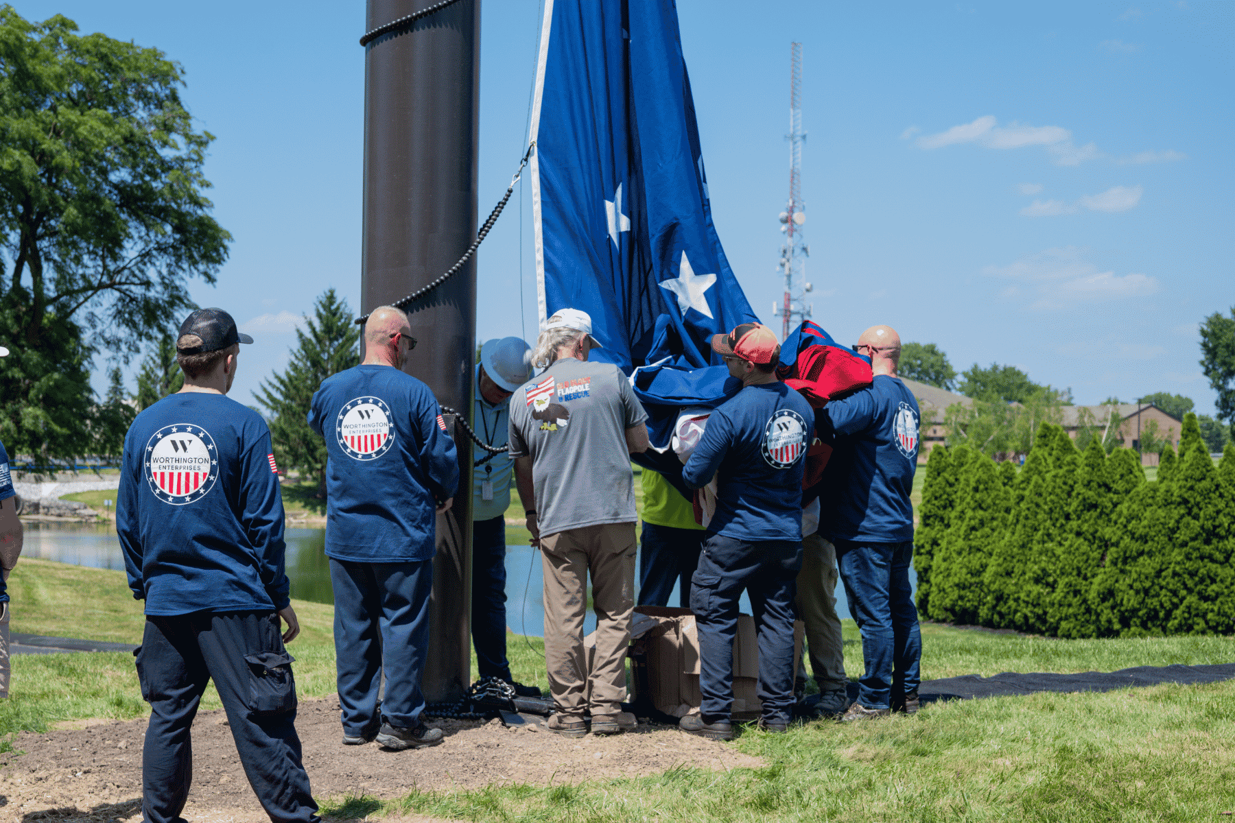 Veteran employees raising flag