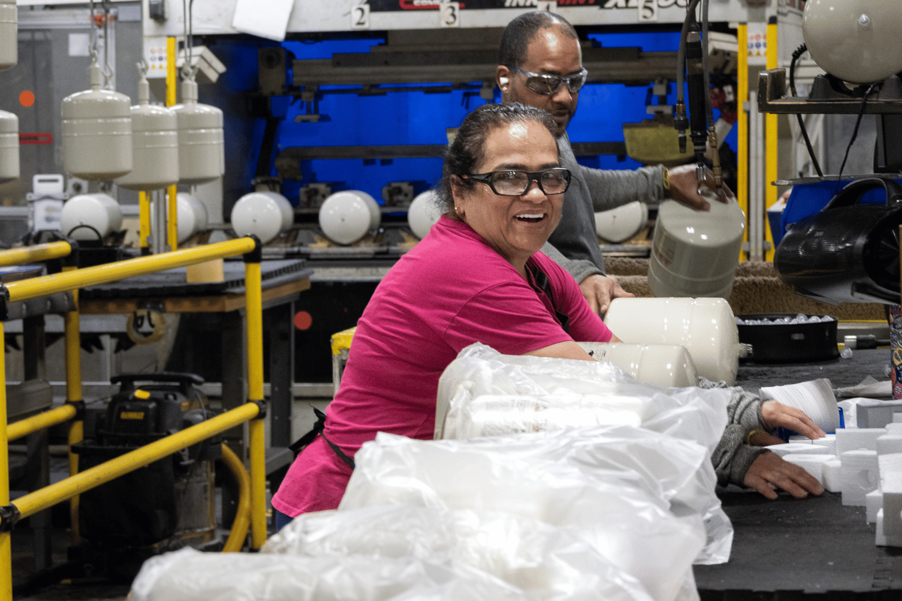 woman employee on asembly line smiling