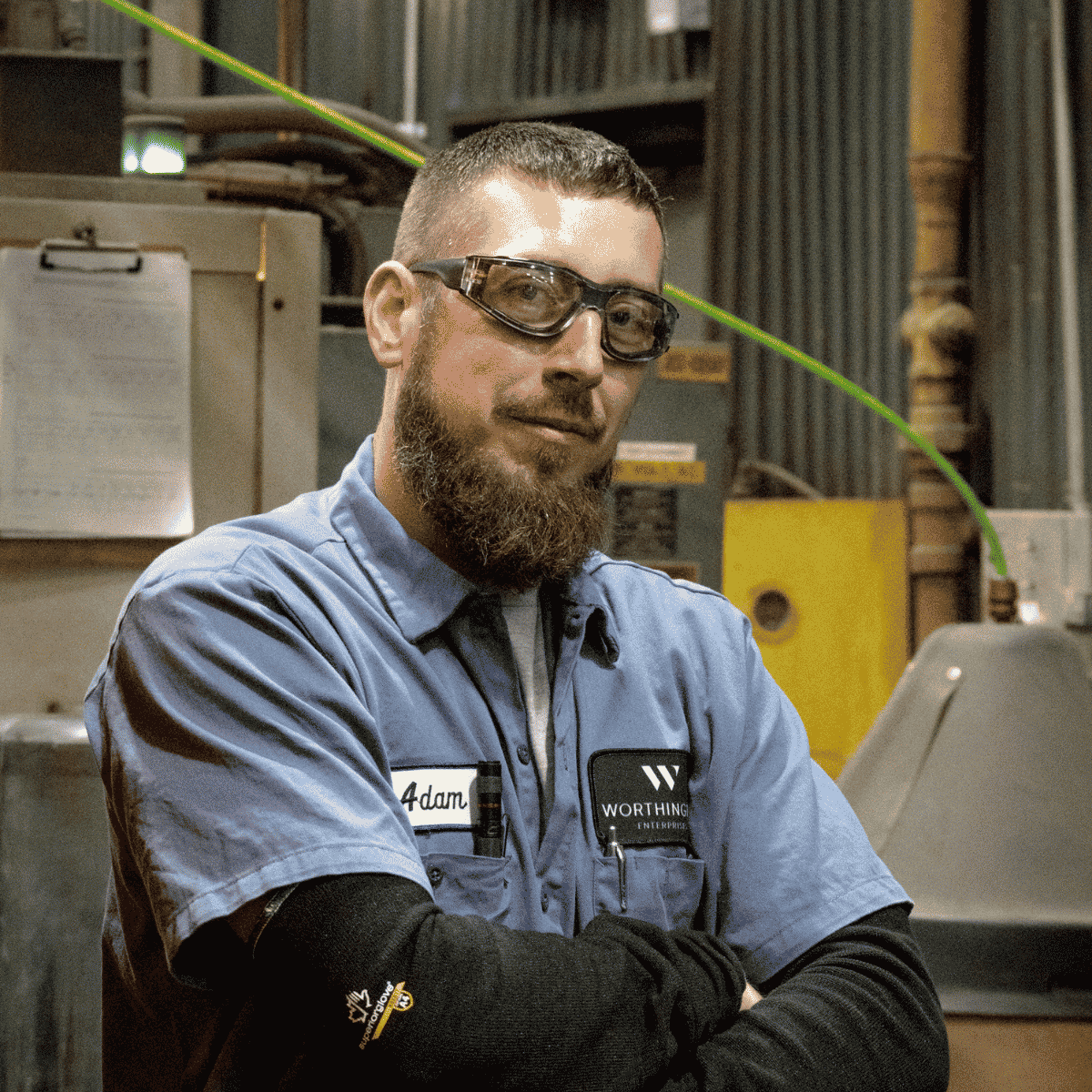 male facility employee with crossed arms