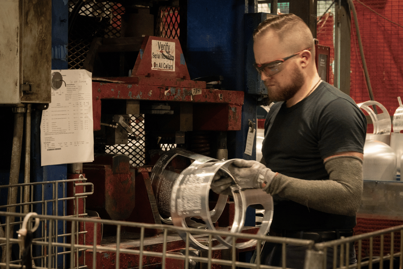 Male employee inspecting cylinder collar